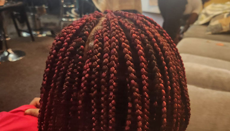 A hair braiding of an African Woman