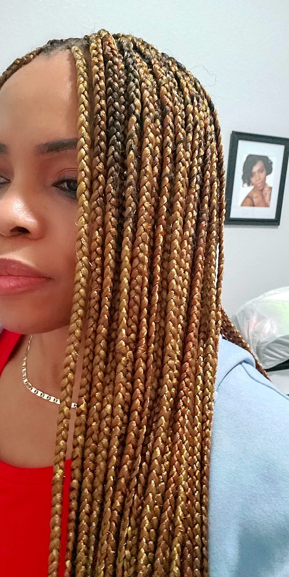 A woman with golden braids looking at the camera